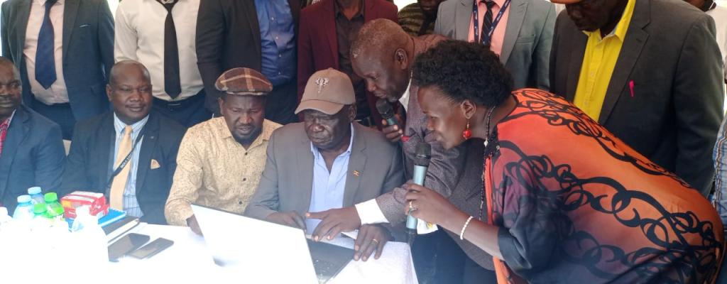 Launch of Parish Development Cash Transfers by Minister for Relief, Disaster Preparedness and Refugees - Hon. Hillary Obaloker Onek (Centre) at Lokung Trading Centre.